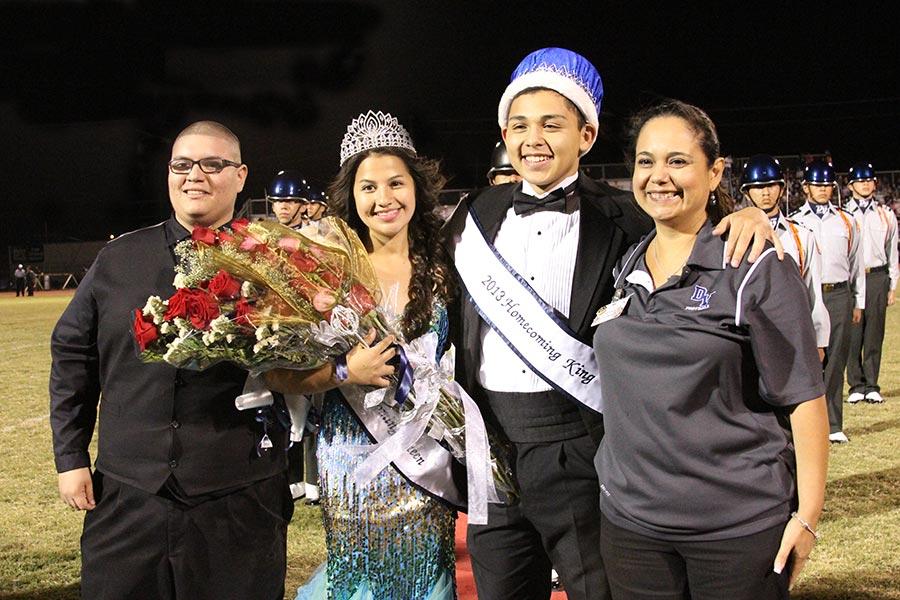 Principal Carmen Crosse and 2012-2013 Homecoming king Daniel next to 2013-14 Homecoming king and queen.