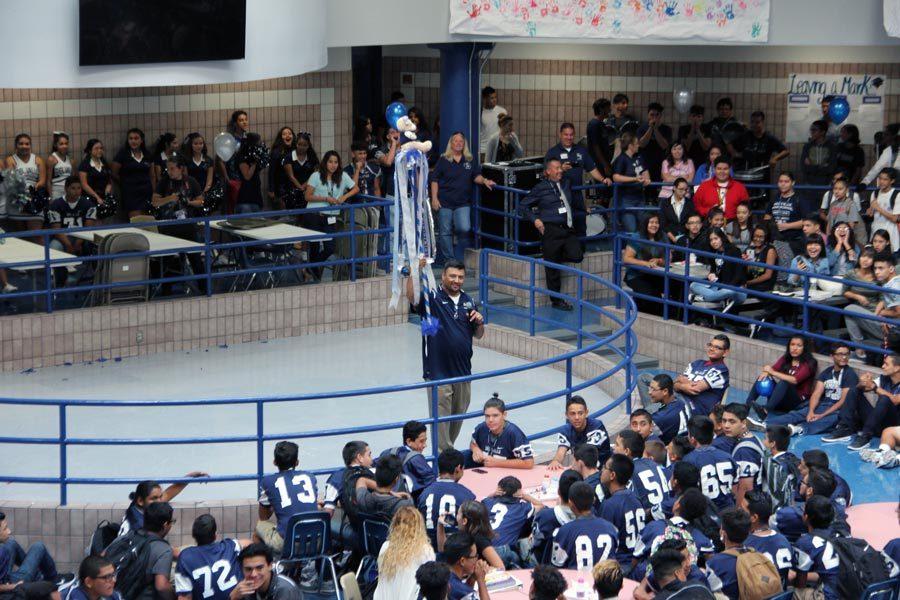 Varsity football coach Jesus Perales motivates the crowd to win the Spirt Stick at the first morning pep rally of the year, held in commons, Sept. 1.