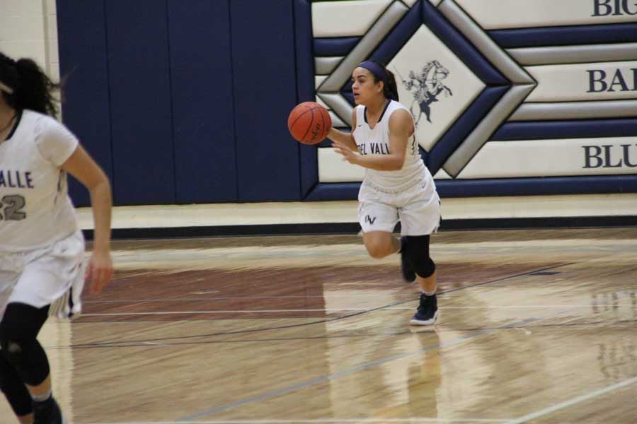 Point guard Desiree moves the ball forward.