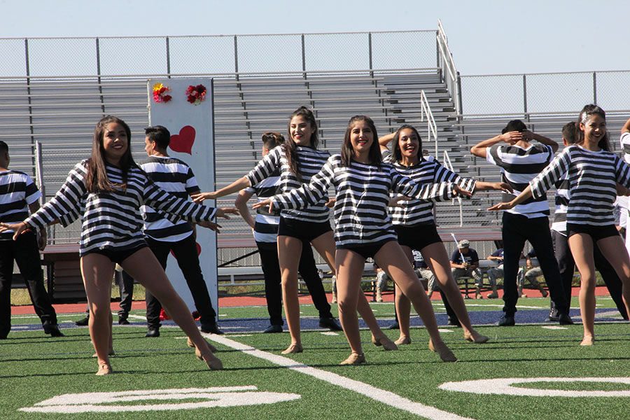 Fuego dances to Jail House Rock by Elvis Presley, at the Homecoming Pep Rally. 