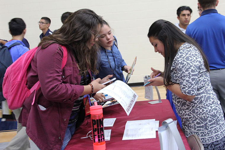 Juniors and seniors head to the west gym to look over college material on College Day, Oct. 24.