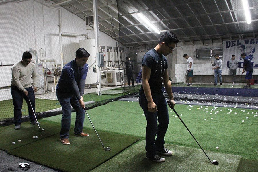 Golf members Alex, Alvaro, and Sam practice their swings for upcoming tournaments. 