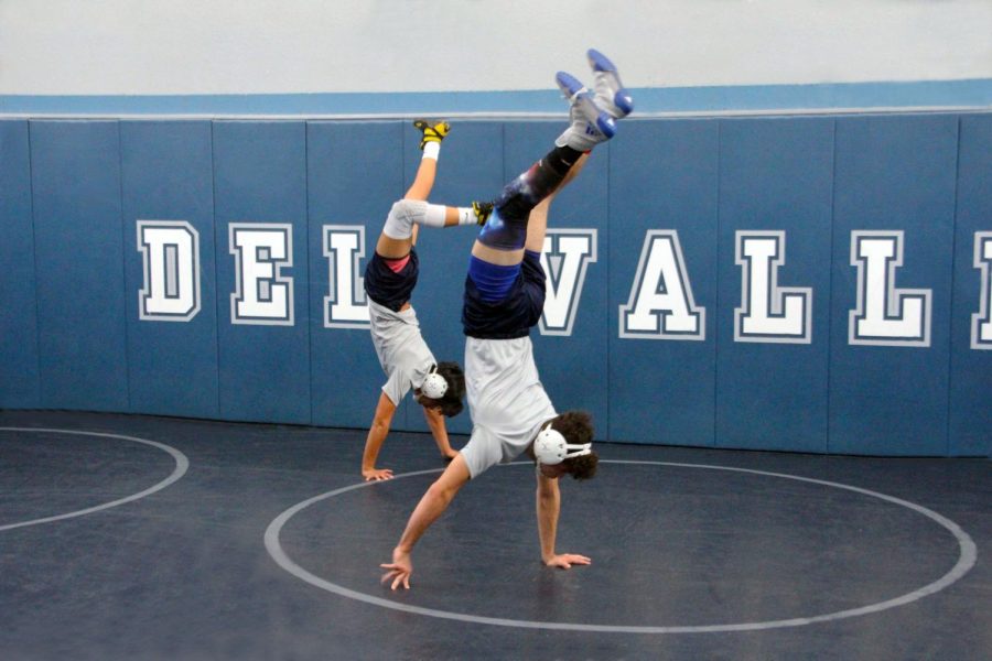 Varsity wrestling captains Elliot and Israel warm up before practice, in the field house, Dec. 11 .