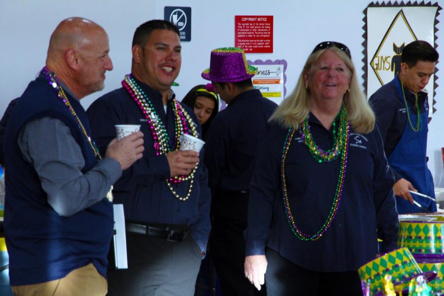 Student council sponsor Cindy Spitz enjoys the Leadership meeting celebrating Mardi Gras Feb. 13, with Chris Lopez and Coach Bruce Reichman.