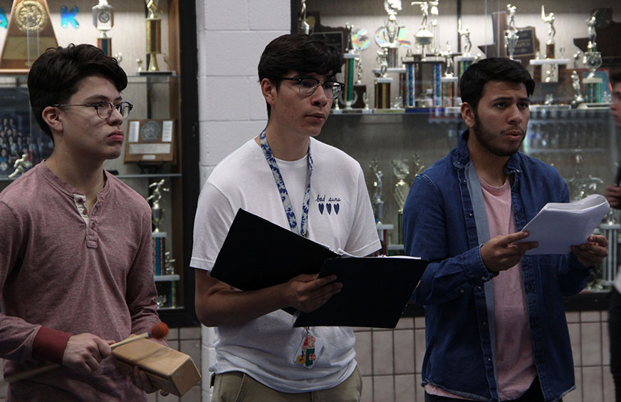 Choir members Marc, Gilbert, and Carlos sing in the foyer during 4th period.