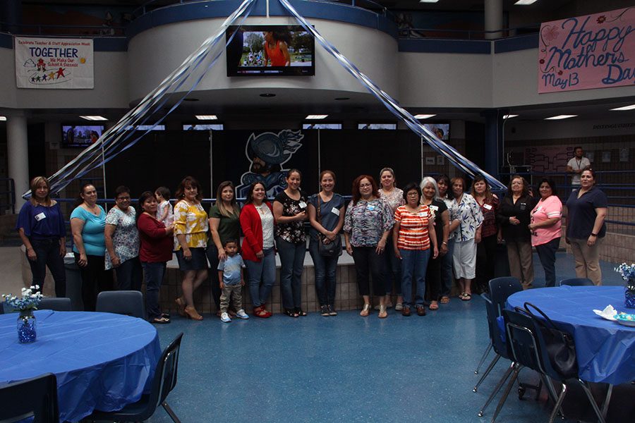 After the breakfast hosted by CIS coordinator Aglaee Hidalgo moms gather for a group photo in the commons, Friday May 11.