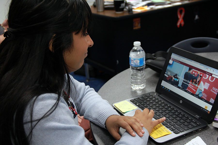Senior Mildred works on her application to New Mexico State University in the Go Center. 