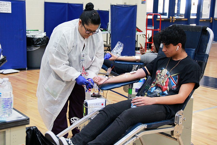 Senior Erik donates blood during study skills.