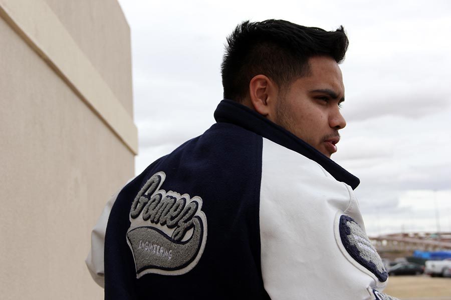 Senior Christopher sports his lettermans jacket on a cold and cloudy day.
