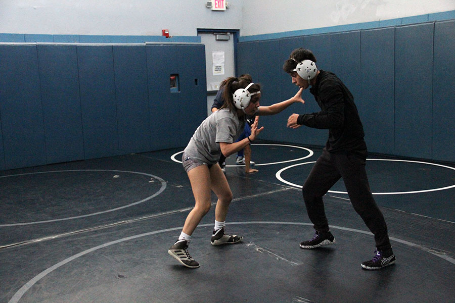 Varsity wrestling team members Annahi Duchene and Diego Estala  practicing techniques after school.