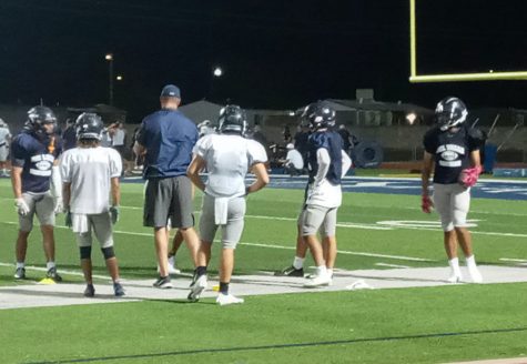 Varsity football coach Contrerass with wide varsity receivers at Midnight Madness practice, August 14.