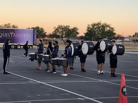 Marching band percussion practices for the Sun City Throwdown in front of the school at 7 a.m.