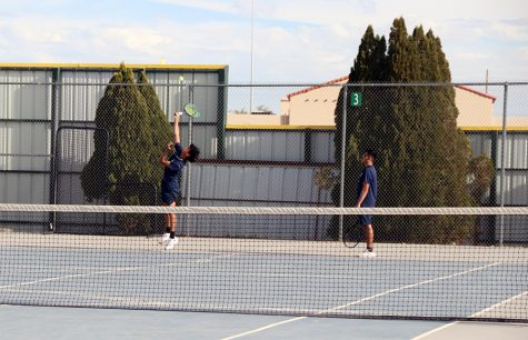 Varsity tennis players, Ezequiel Barron and Kristo Perez practice during spring season.