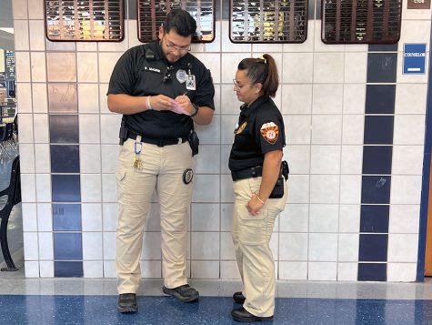 New security officers, Jasmine Brambila, and Daniel Madrid Jr. work  during 9th period in front of the counselors offices.